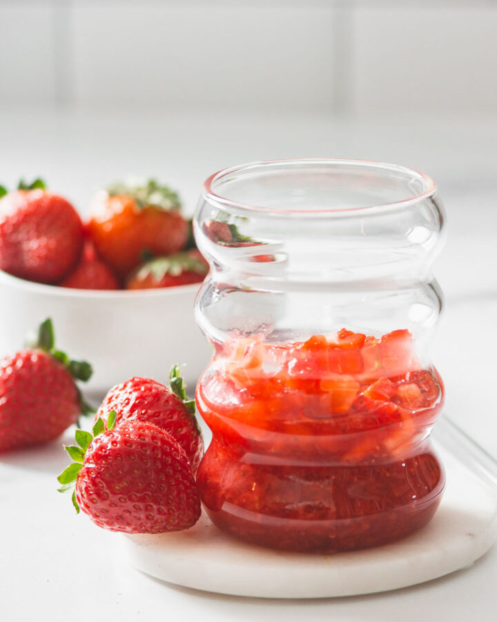 Strawberry jam and strawberry pieces  inside a cup ready for milk and mixing.