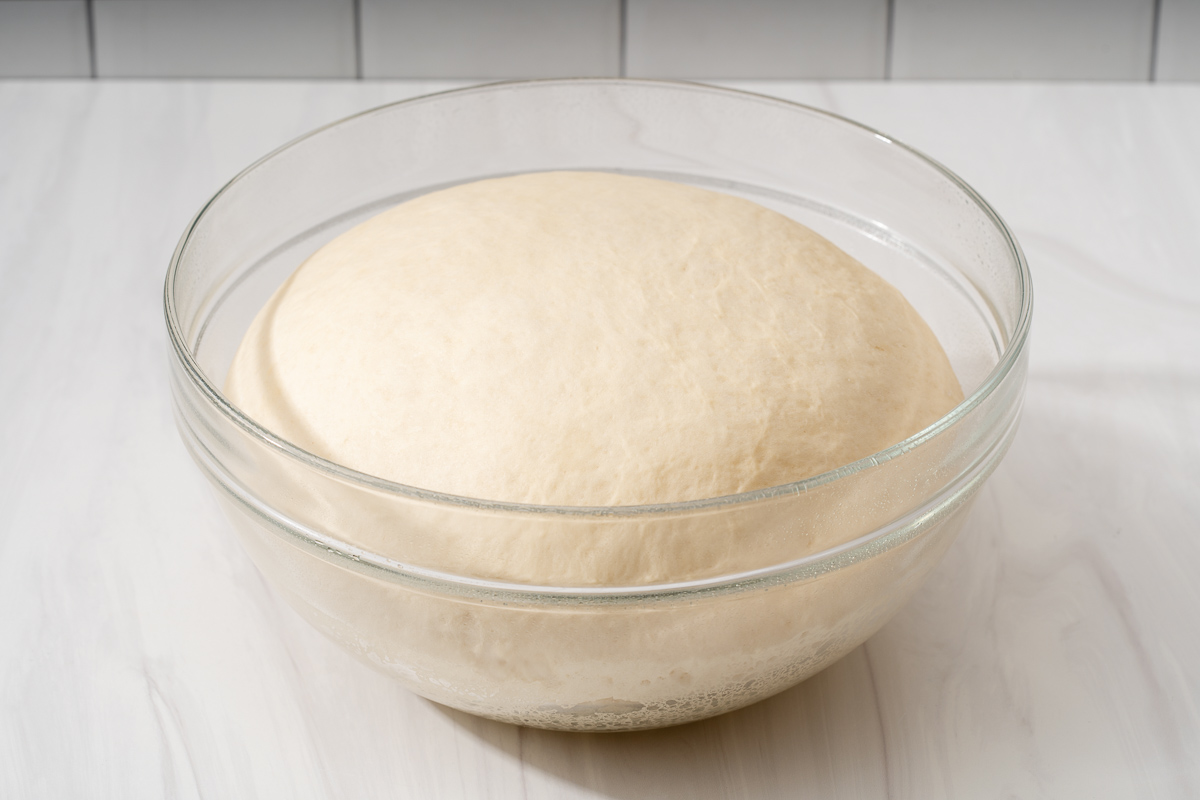 Dough in a mixing bowl after proofing and rising.