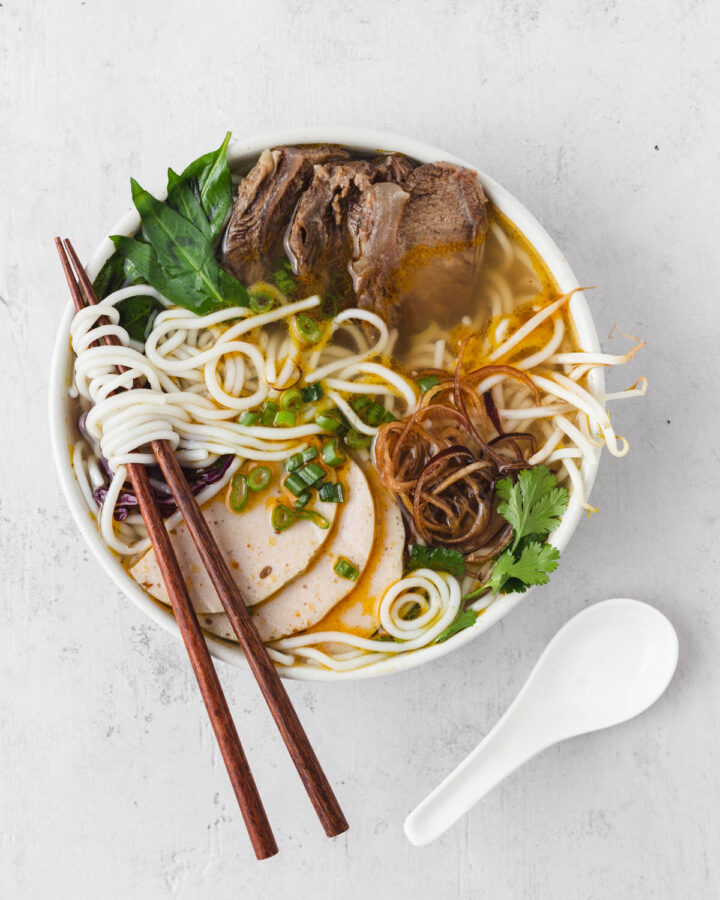 Bun bo hue bowl stand alone with chopsticks and spoon