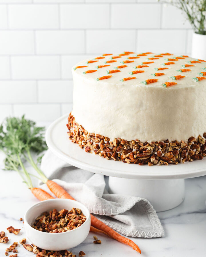 Full image of a cake and pecans on the side
