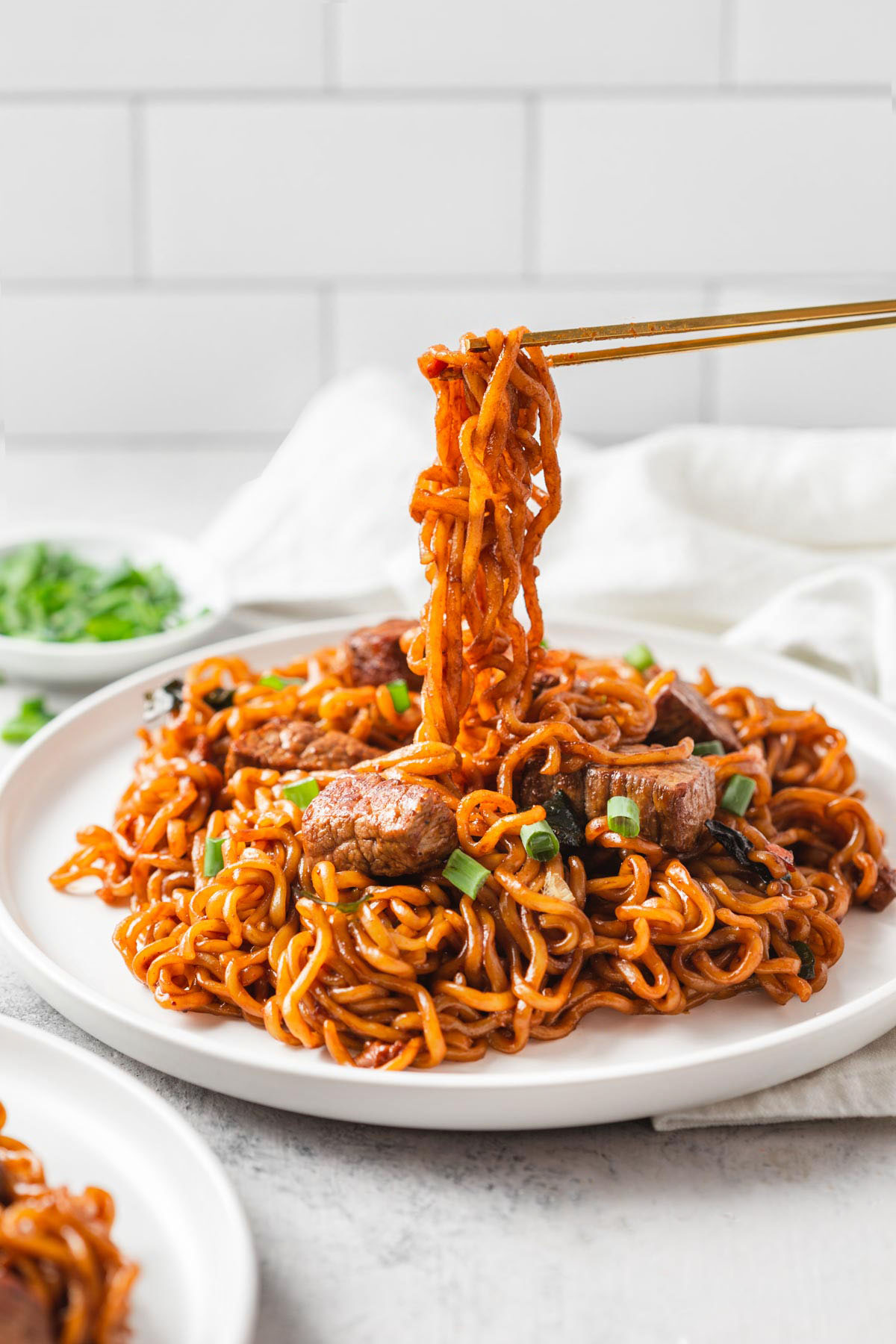 chop sticks lifting up jjapaguri noodles