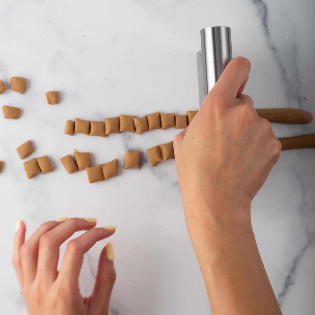 Cut tapioca dough into small pieces using bench scraper