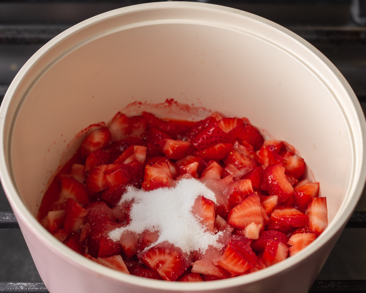 a pot with diced strawberries and sugar ready to be cooked