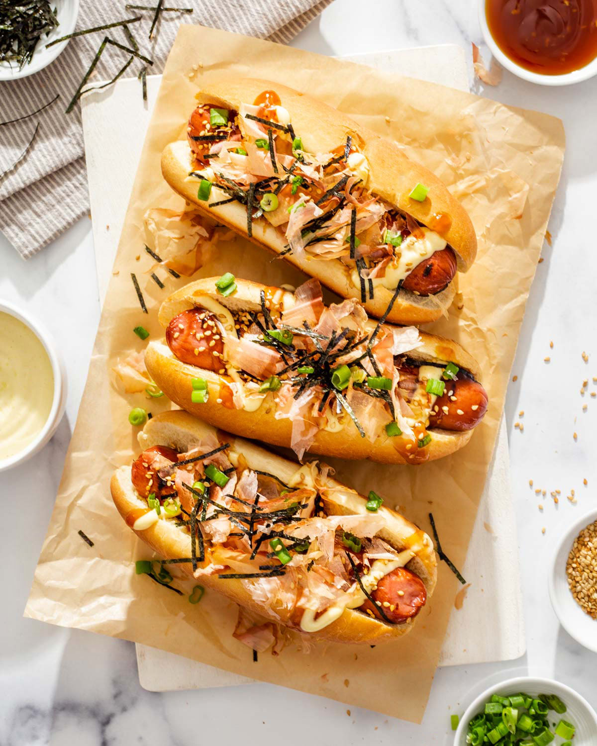 A platter of three japanese hot dogs