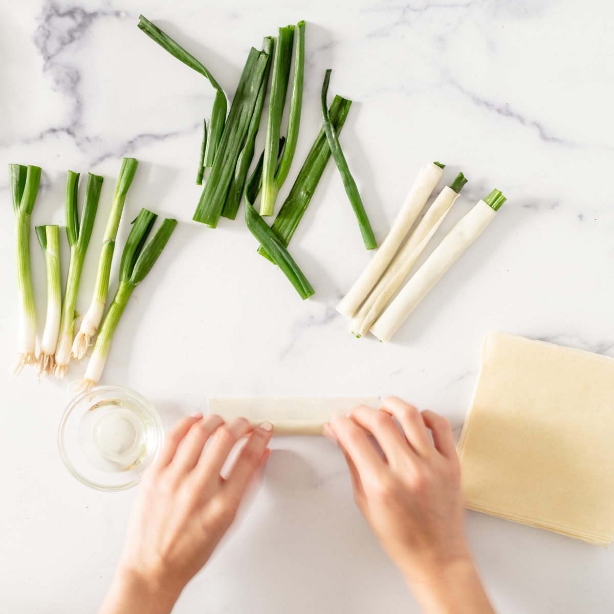 rolling spring onion in egg wrappers