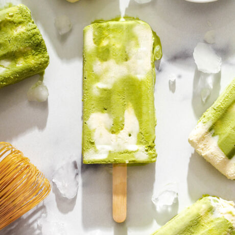 Close up of a matcha cheese foam popsicle.