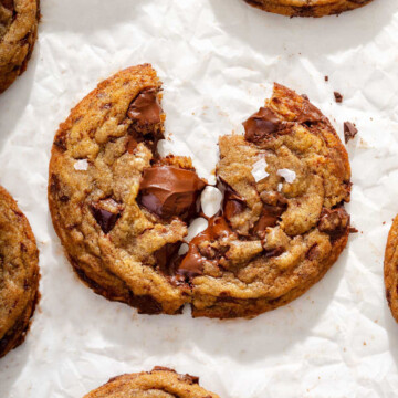 Close up of a pulled apart melty chocolate chip cookie