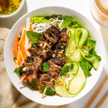 Looking down at grilled Vietnamese pork plated in a bowl.