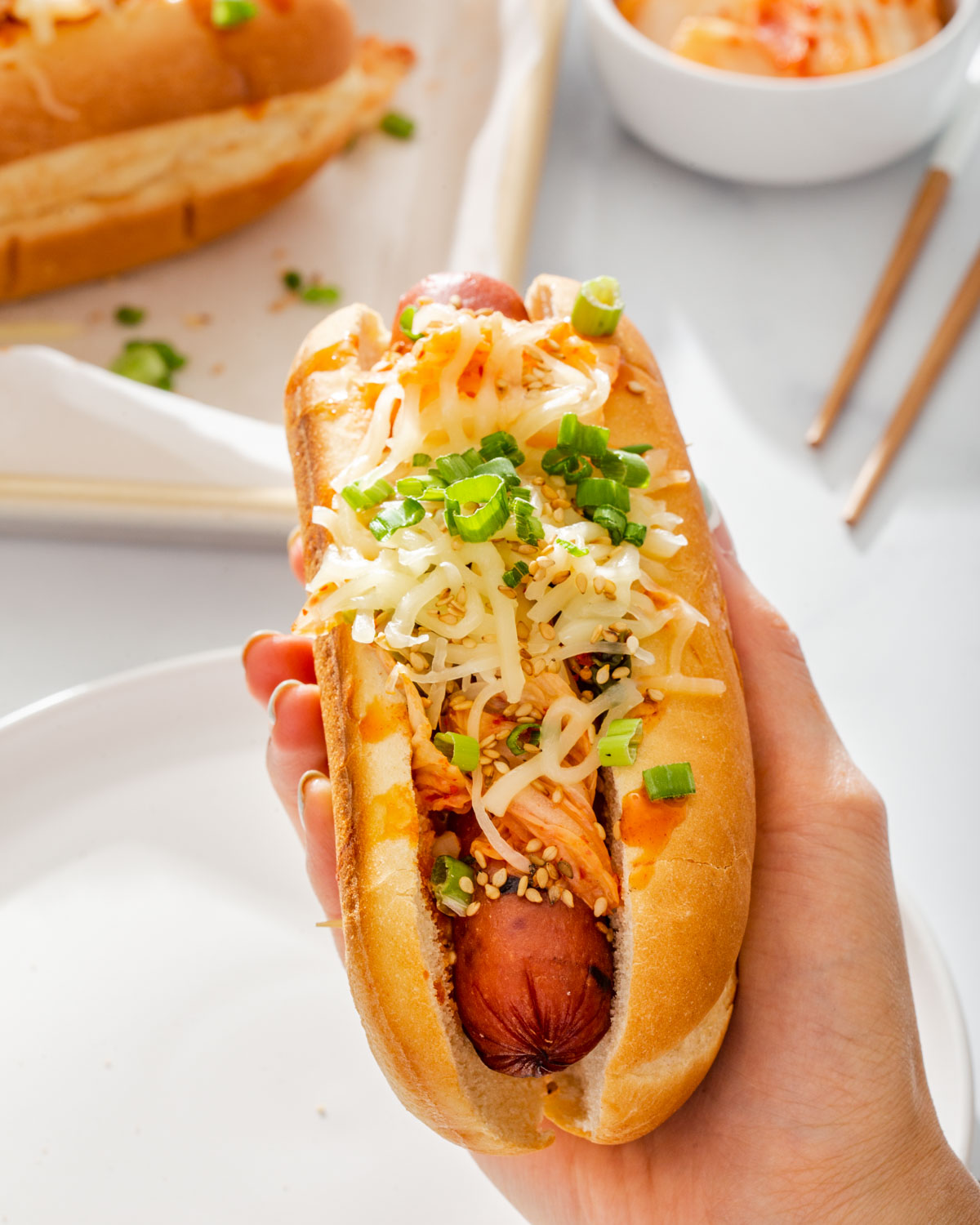 Someone holding a Korean hot dog up close