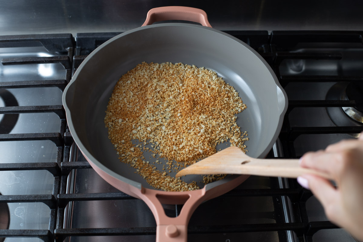 Toasting panko breadcrumbs in a skillet on the stove