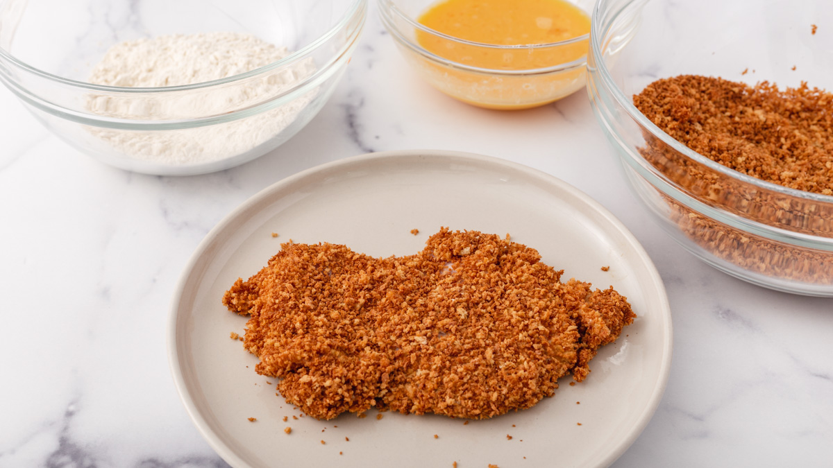 A chicken thigh dredged in flour and toasted panko crumbs