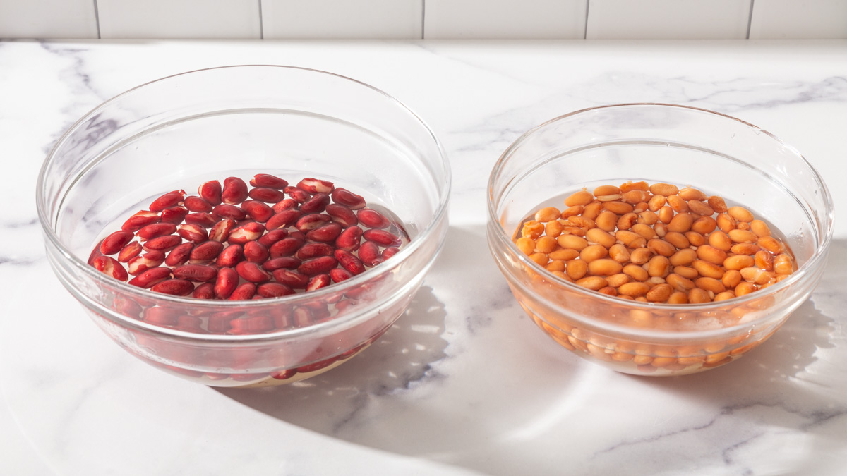 Two types of beans each soaking in sweetened water