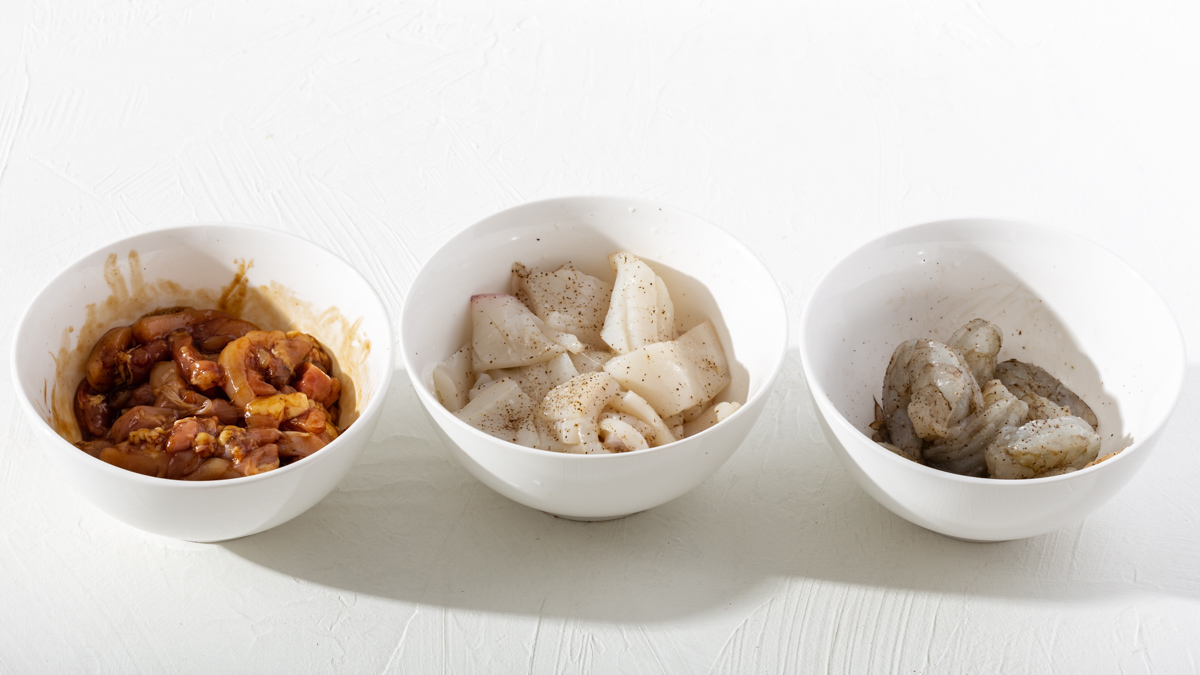 Three prepared proteins in bowls ready for stirfrying