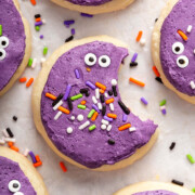 A detail of a purple loft house cookie with a bite out of it