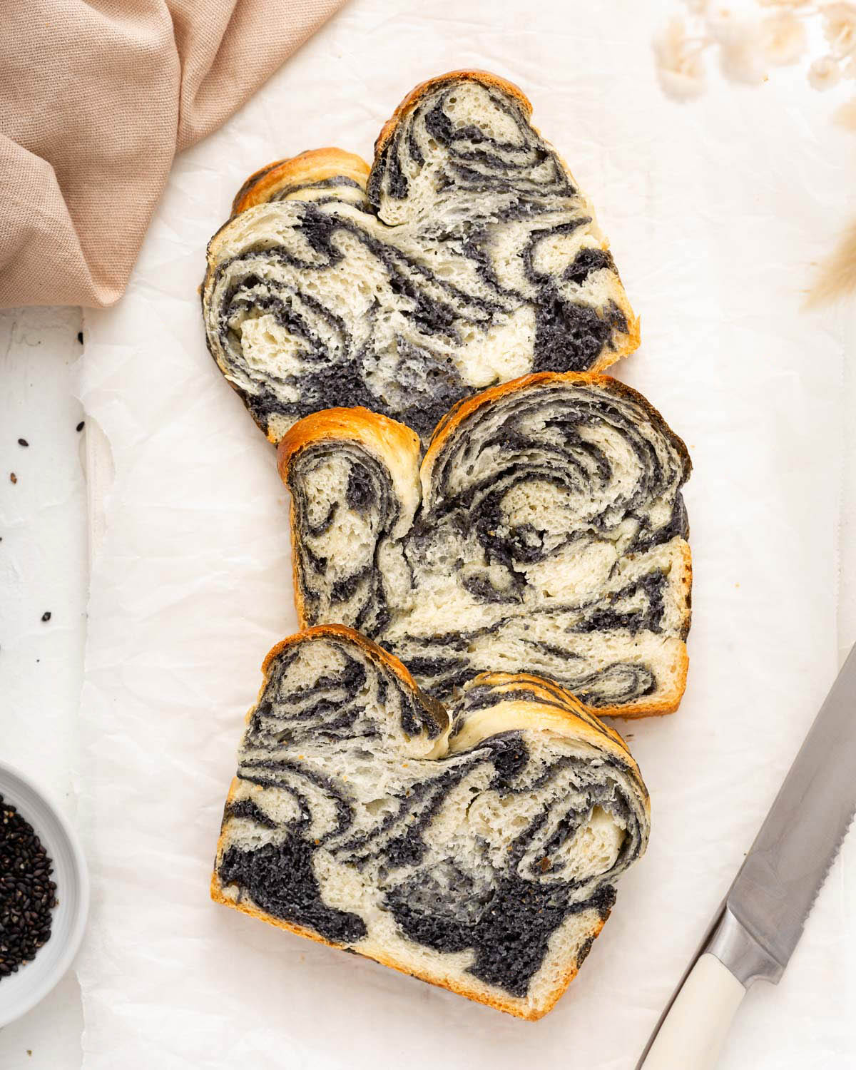 Slices of marbled bread on a cutting board with parchment paper.