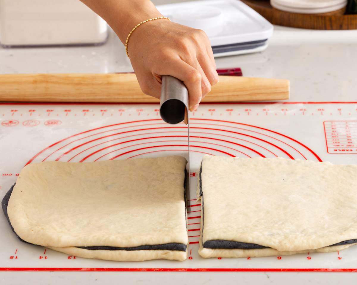 Cutting the rolled dough in half.