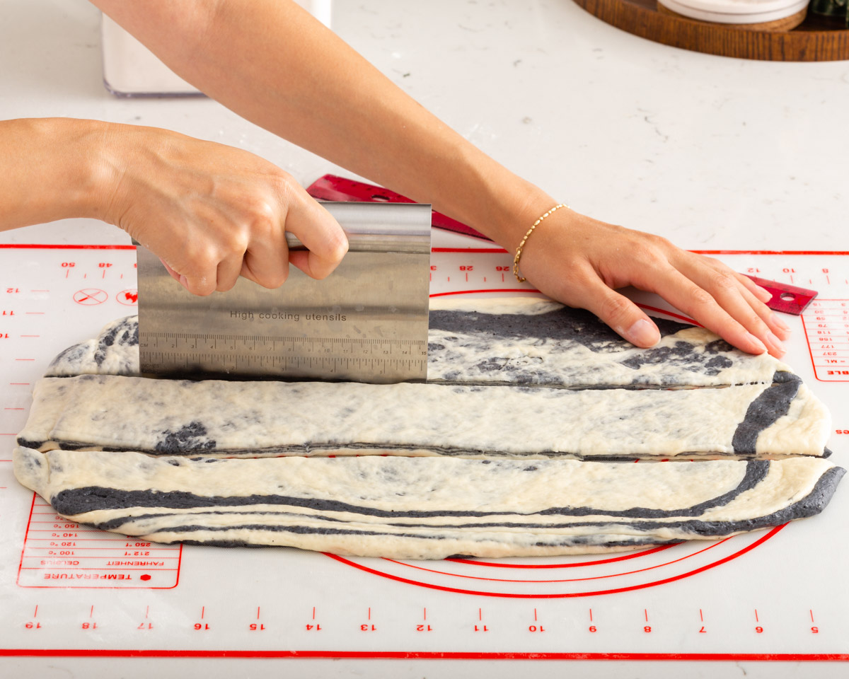 Slicing the layered dough into thirds.