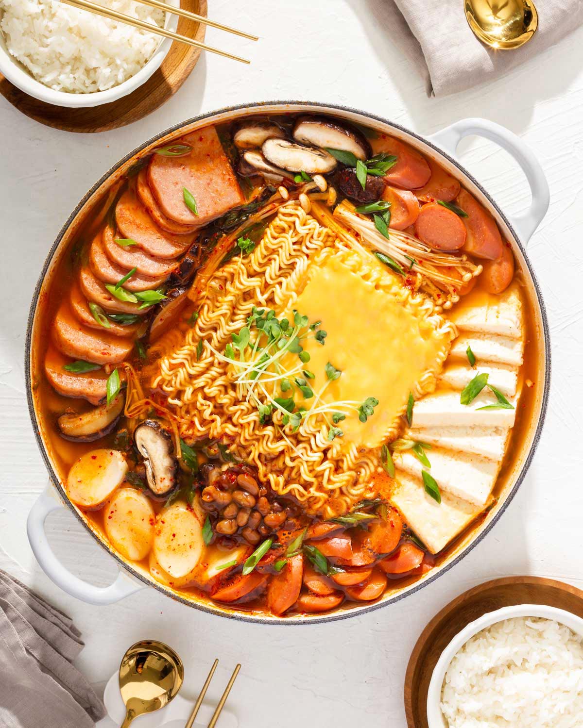 Looking down into a large pot of Korean budae jjigae.