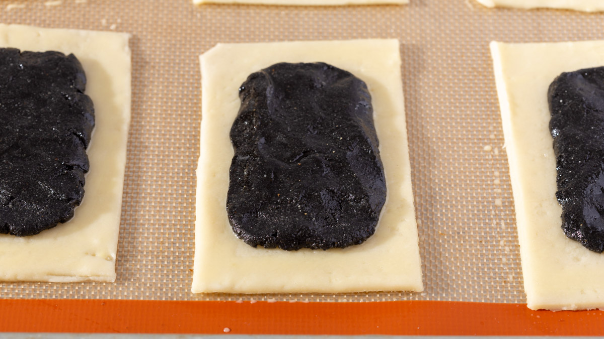 A bed of black sesame paste in the center of the pastry dough