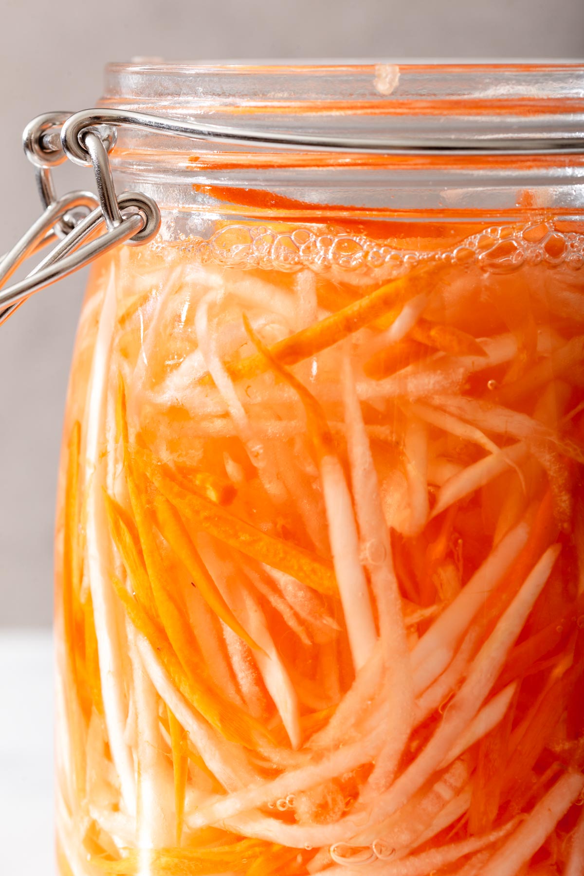 A jar of Vietnamese do chua marinading in a lock tight jar