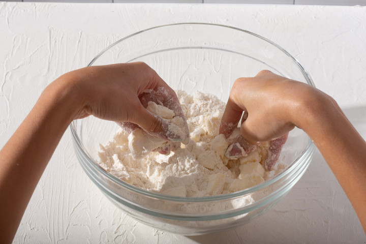 Mixing together butter and flour in a mixing bowl