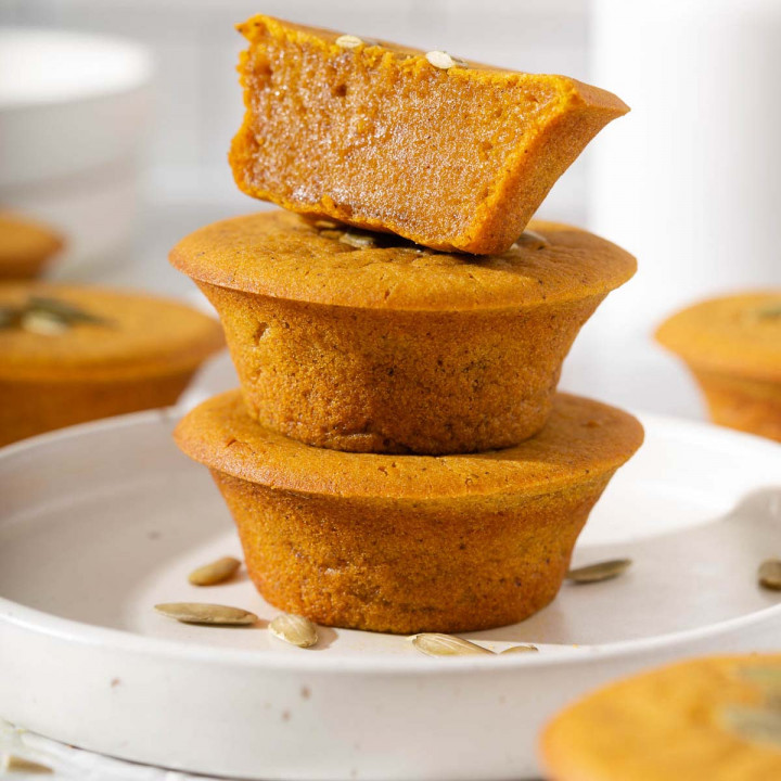Up close of a stack of pumpkin mochi muffins on a plate