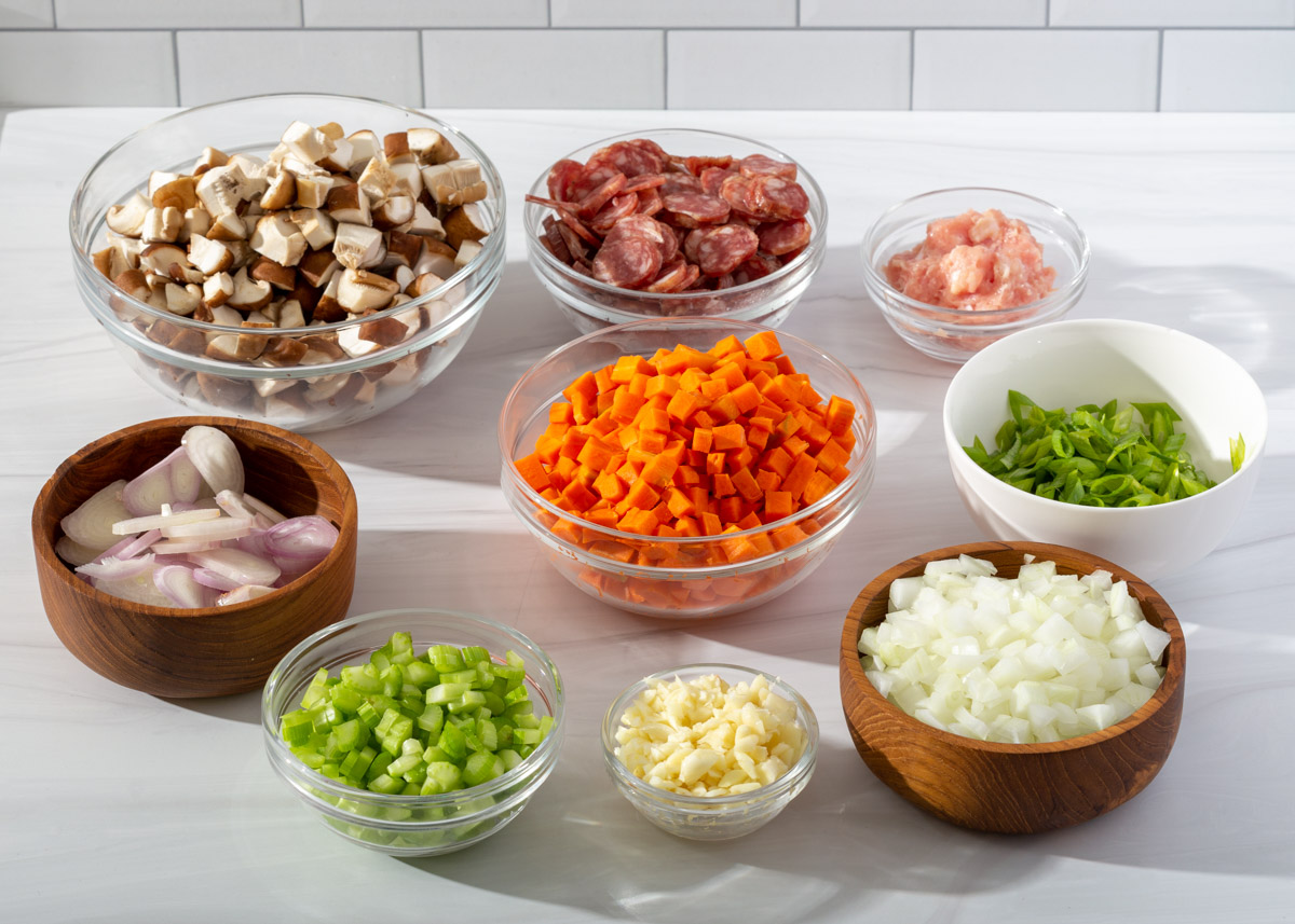 Various ingredients diced and prepared in individual bowls