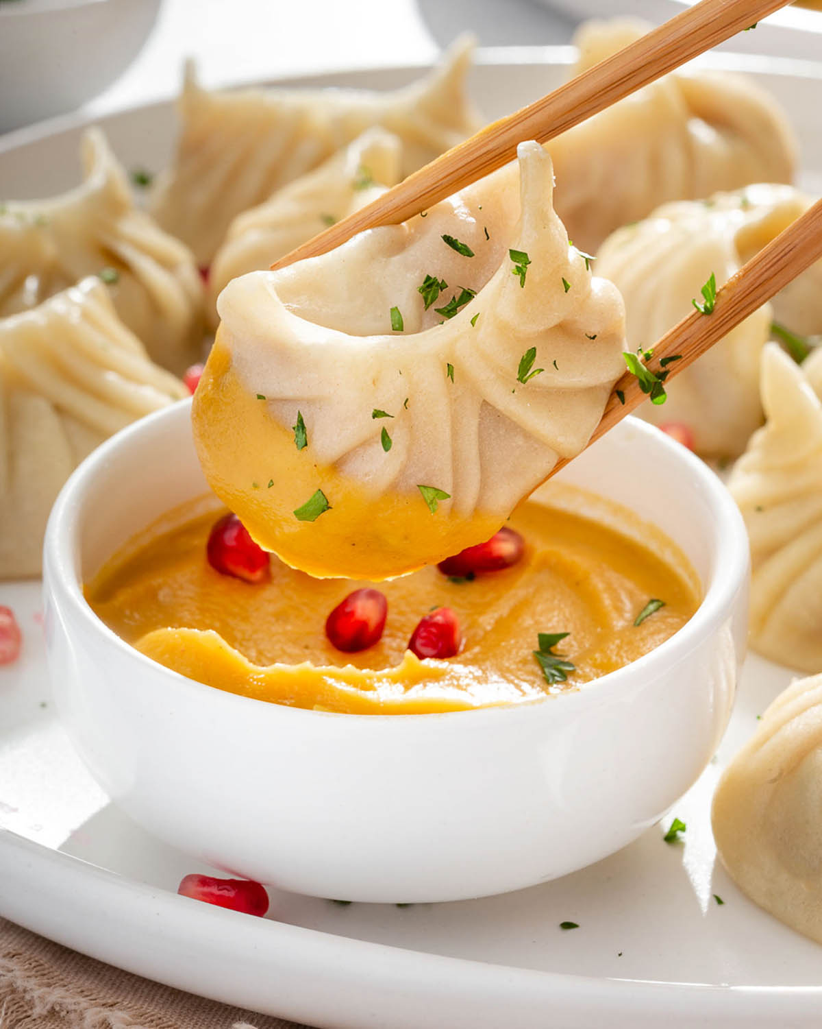 Dipping a turkey dumpling into butternut squash puree