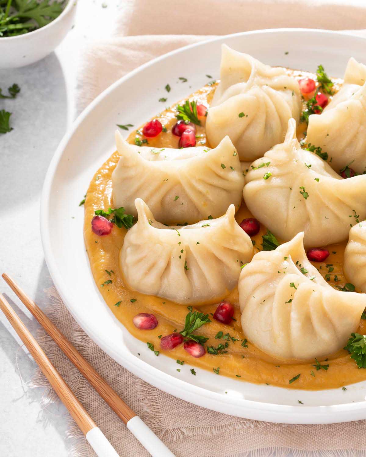 Up close of a plate of turkey dumplings with a butternut squash puree