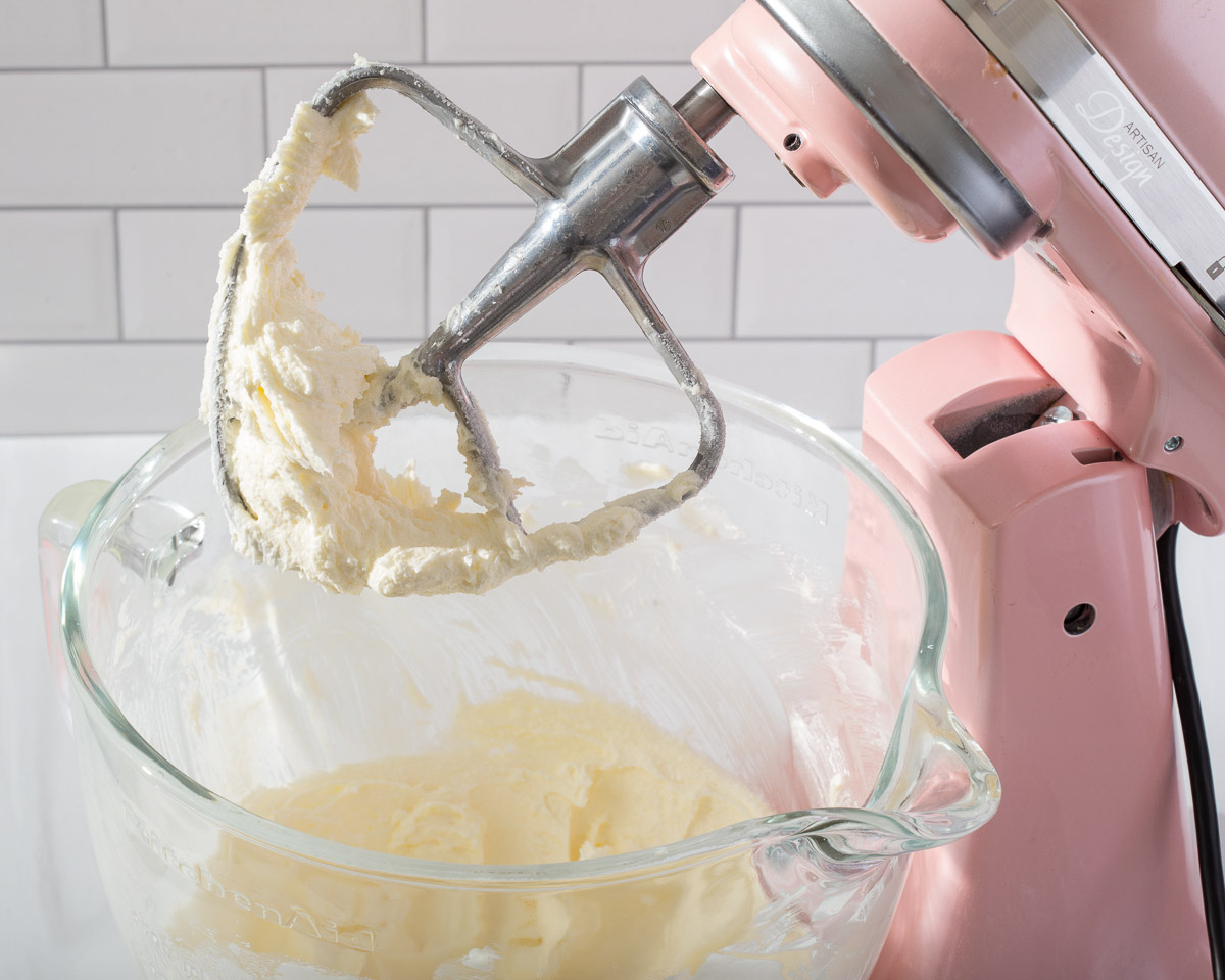 A stand mixer with the wet ingredients blended together
