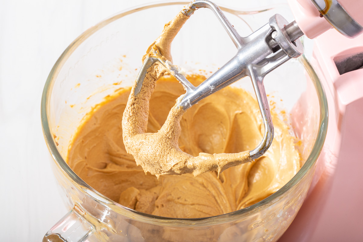 The wet ingredients for gingerbread cookies blended together in a stand mixer