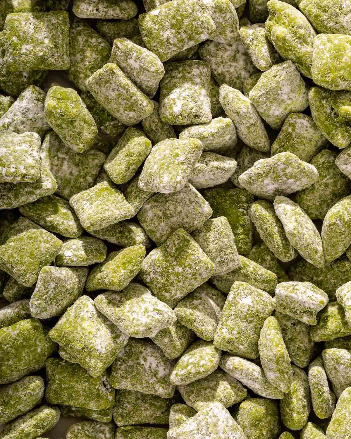 Up close of a pile of matcha puppy chow.
