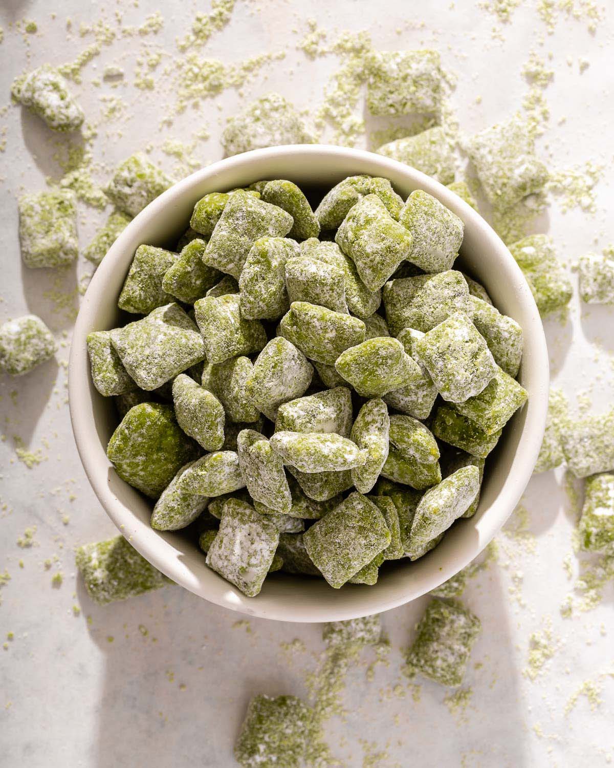 Looking down into a bowl of puppy chow that is made with matcha