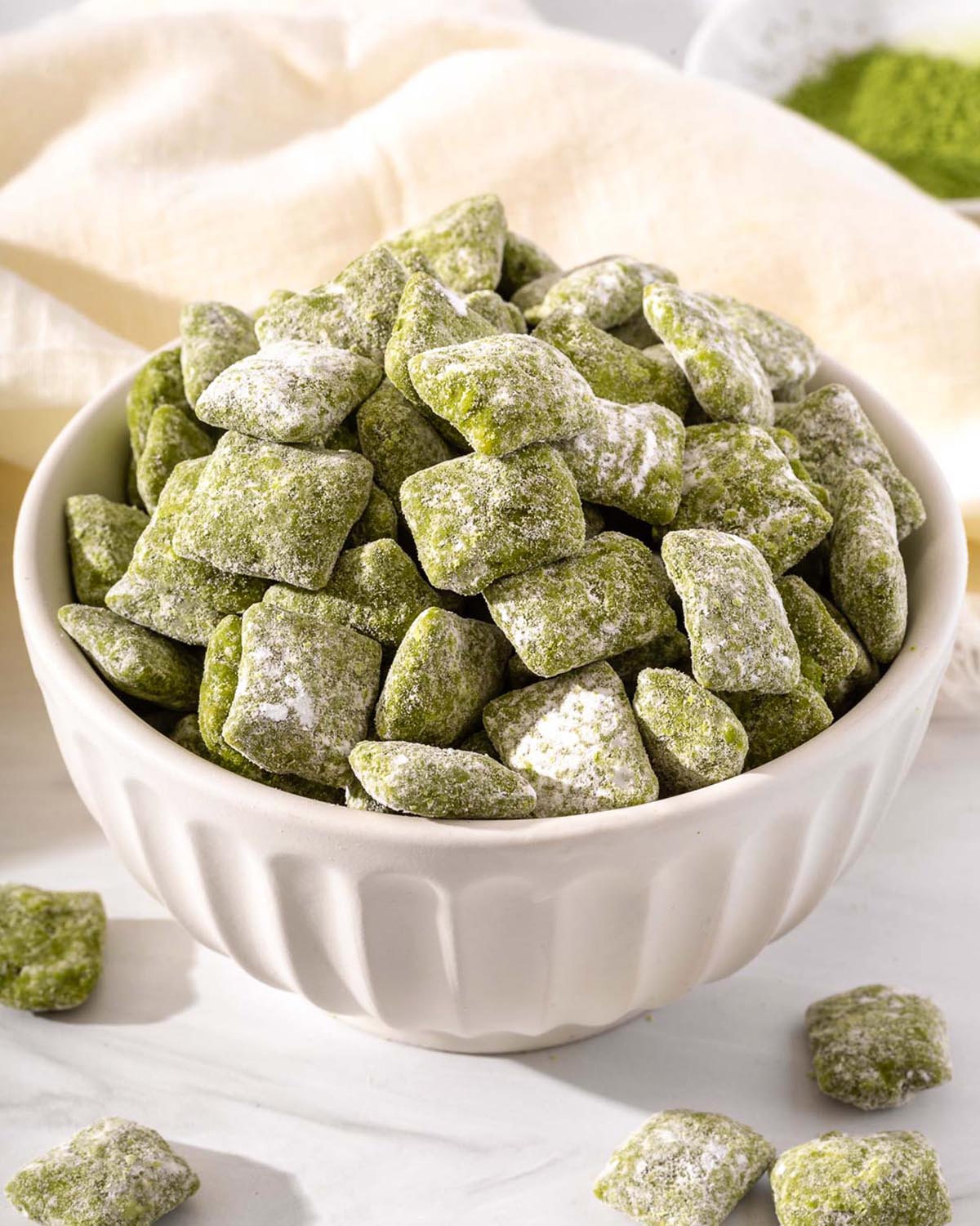 A bowl overflowing with green puppy chow.
