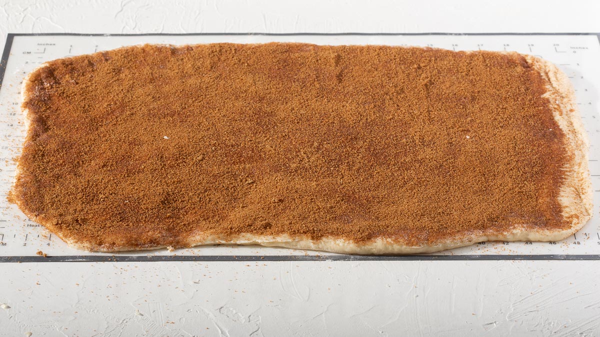 A dough slab topped with butter and cinnamon and sugar