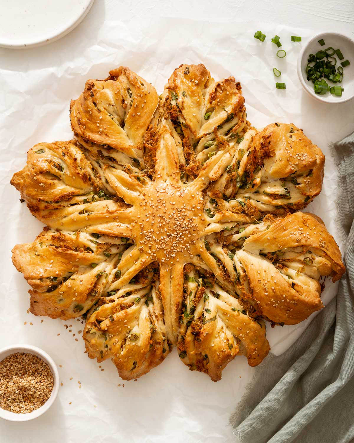 An overhead view of pork floss star bread with scallions.