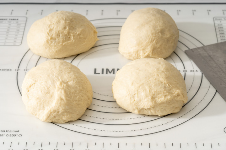Milk bread dough separated into fourths to make layered star bread.