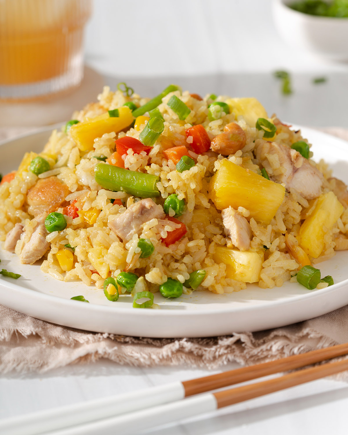 Up close of a plate with a mound of pineapple fried rice ontop.