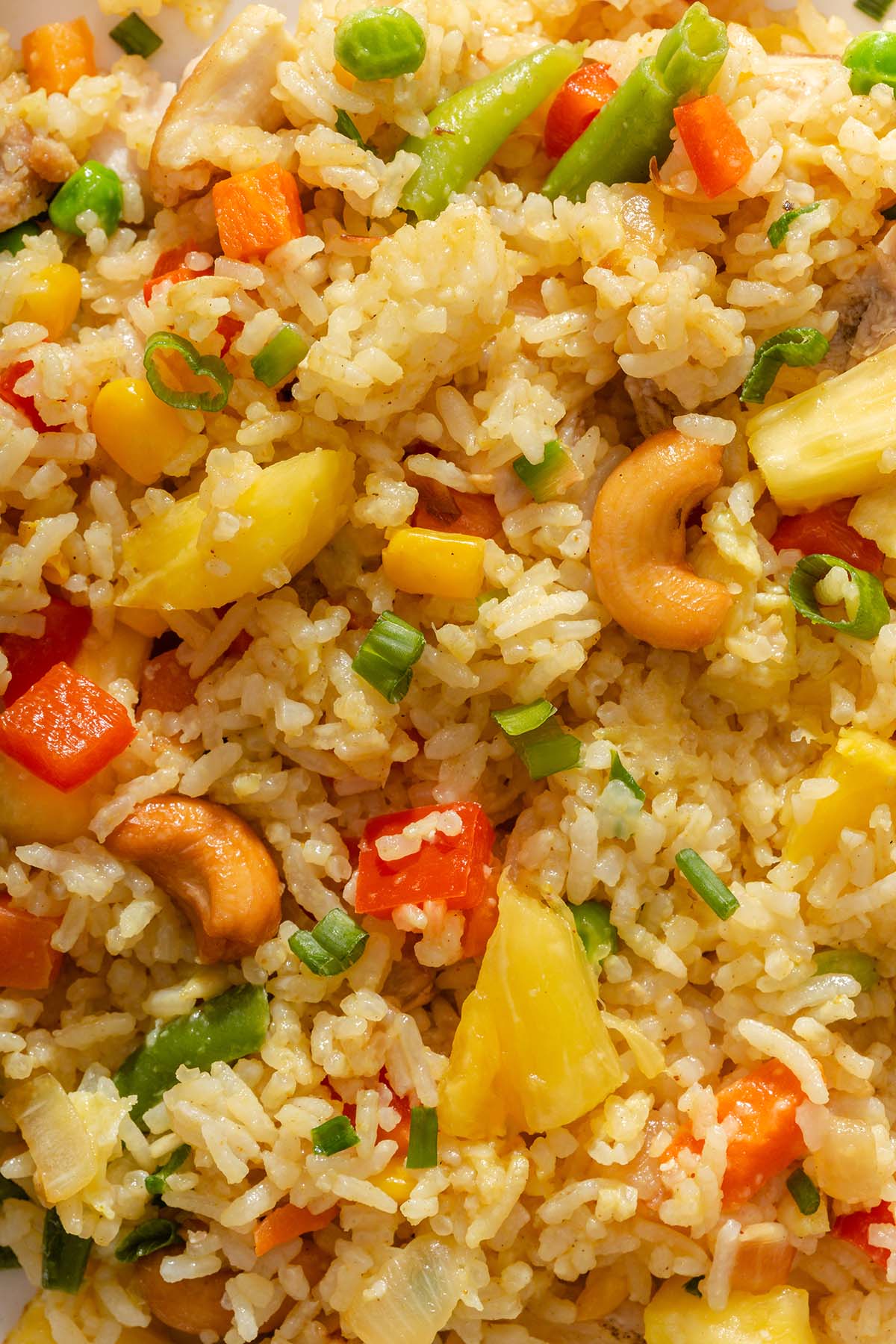A detail shot of pineapple fried rice showing off all the various ingredients mixed within.