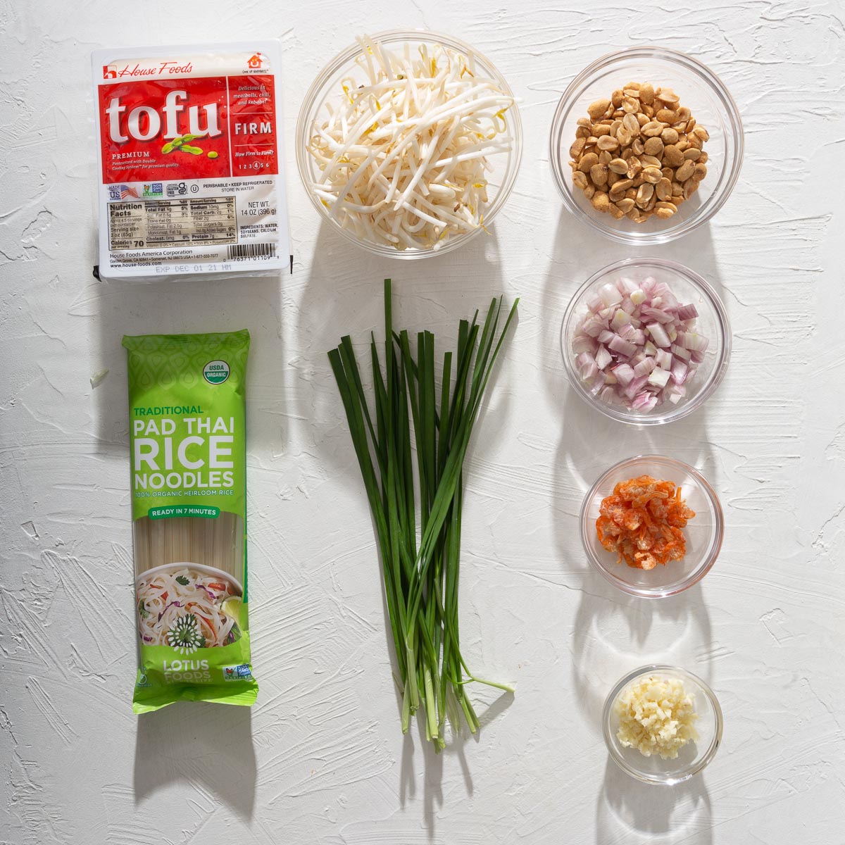 A grid of the various ingredients in separate containers to make pad thai.