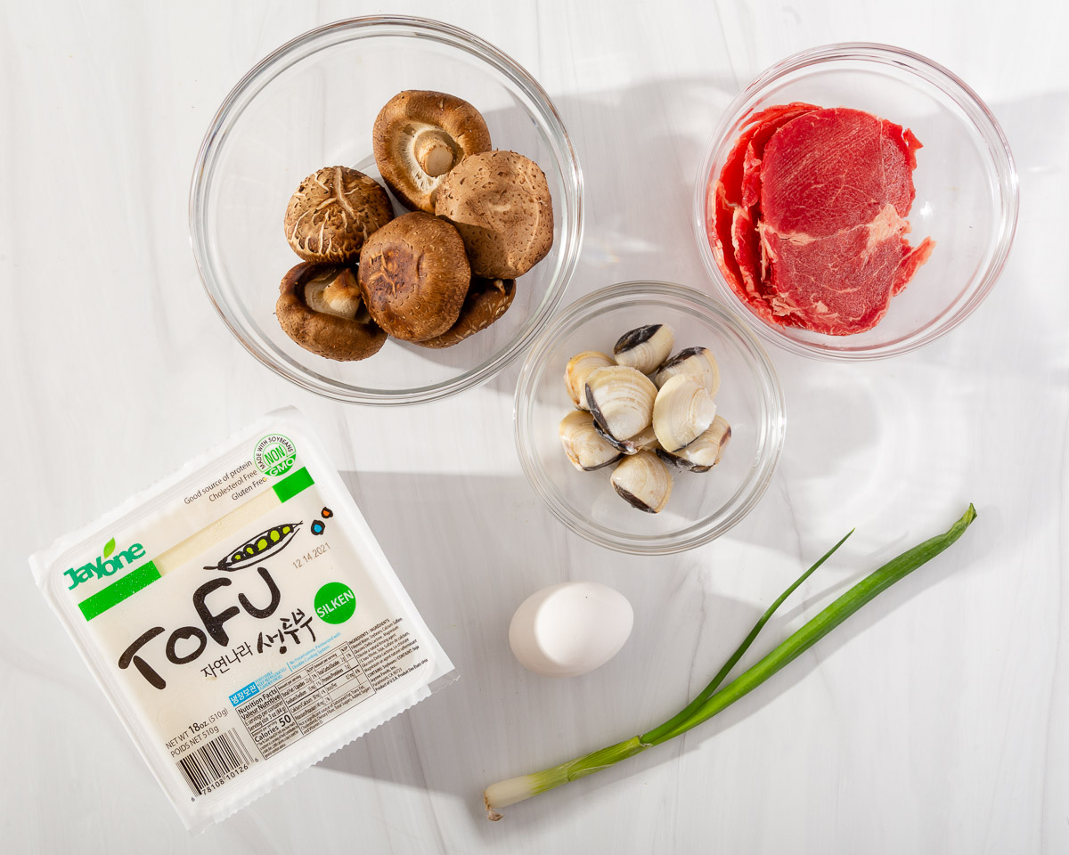 The toppings to add into spicy Korean tofu soup.