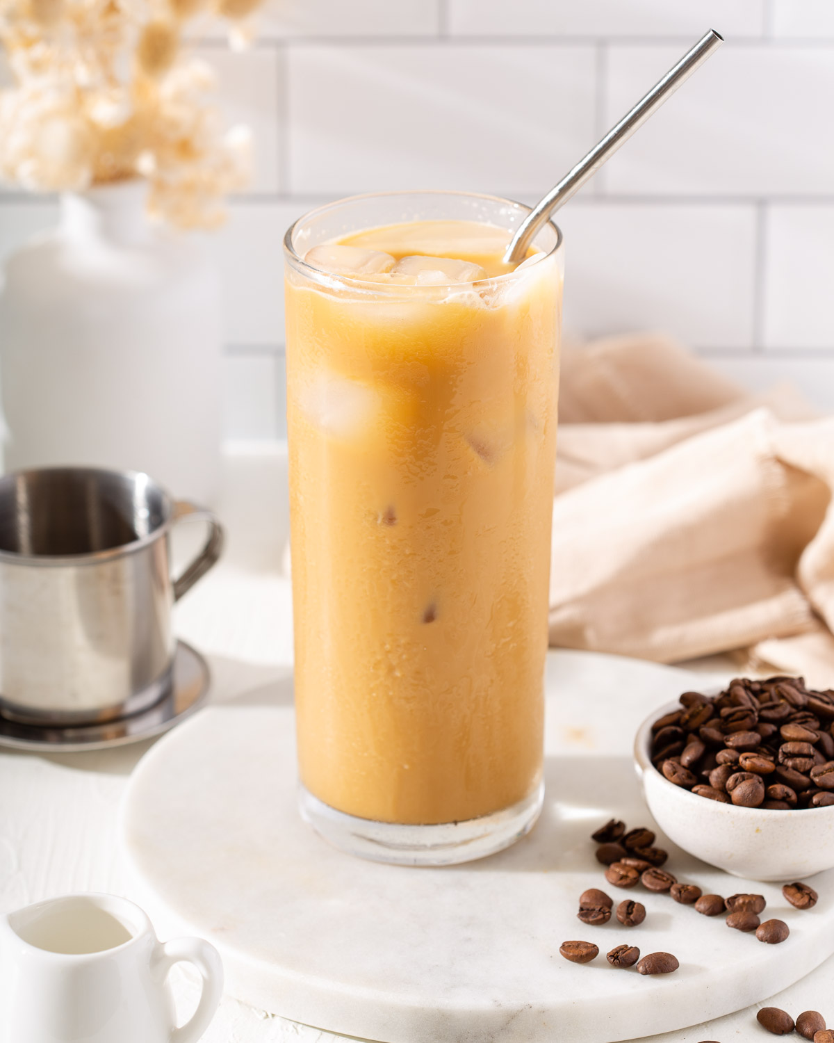 A tall glassed of iced Vietnamese coffee all mixed together.
