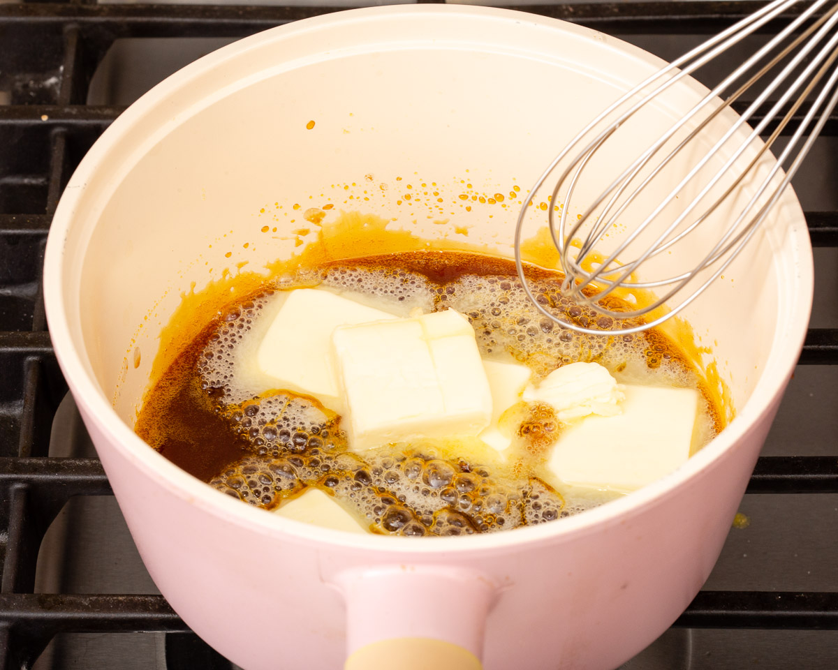 Butter sizzling in a sauce pan of hot melted sugar.