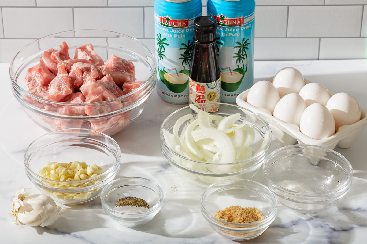 Ingredients inside glass mixing bowls ready to prepare thit kho trung.