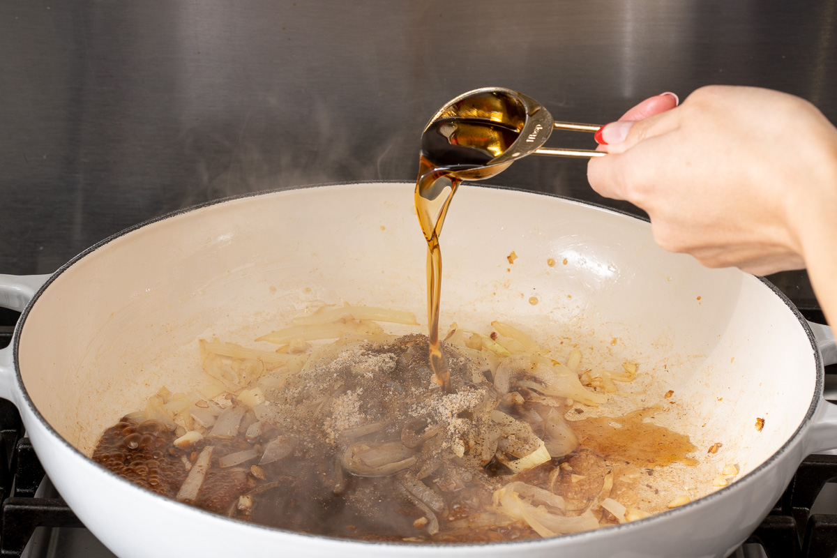 Adding the next sauce to the base for cooking the short ribs.