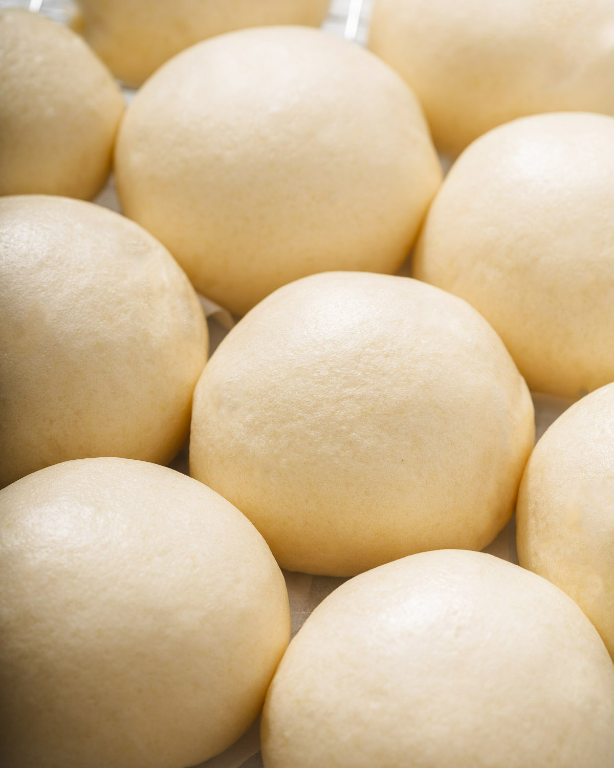 A grid of freshly steamed Chinese buns known as mantou.