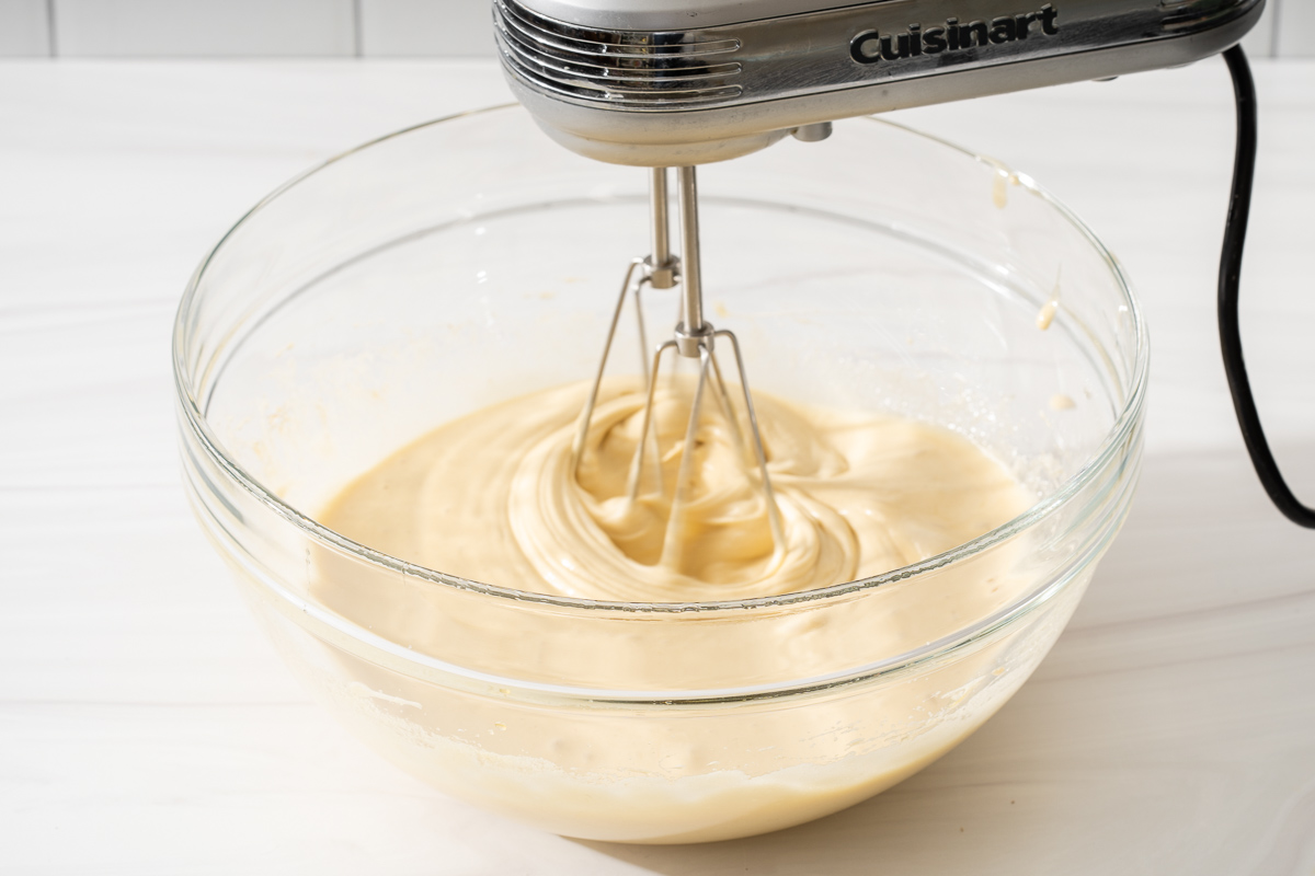 Whisking the liquid ingredients with an electric mixer.