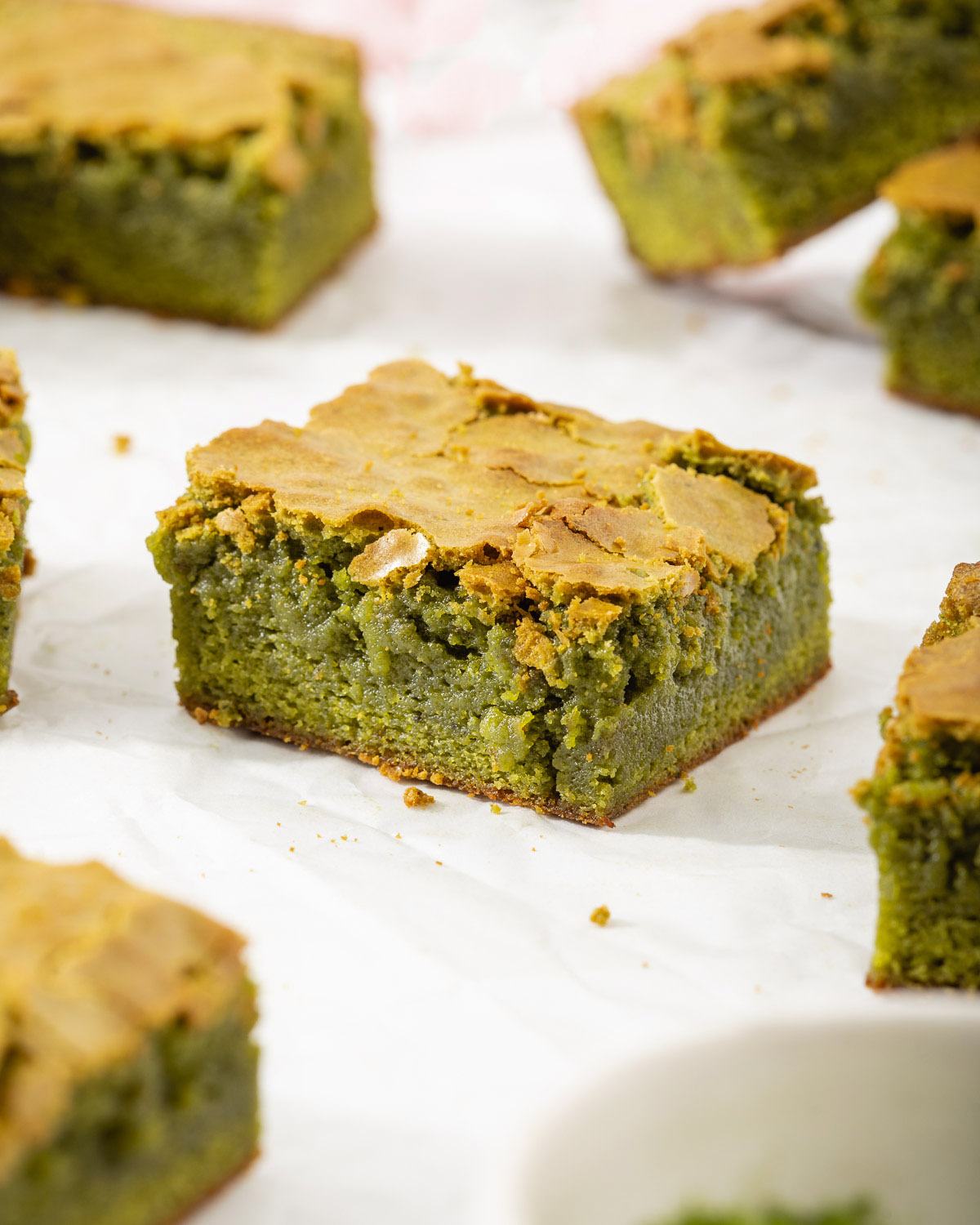 Up close with a slice of matcha brownie on parchment paper.