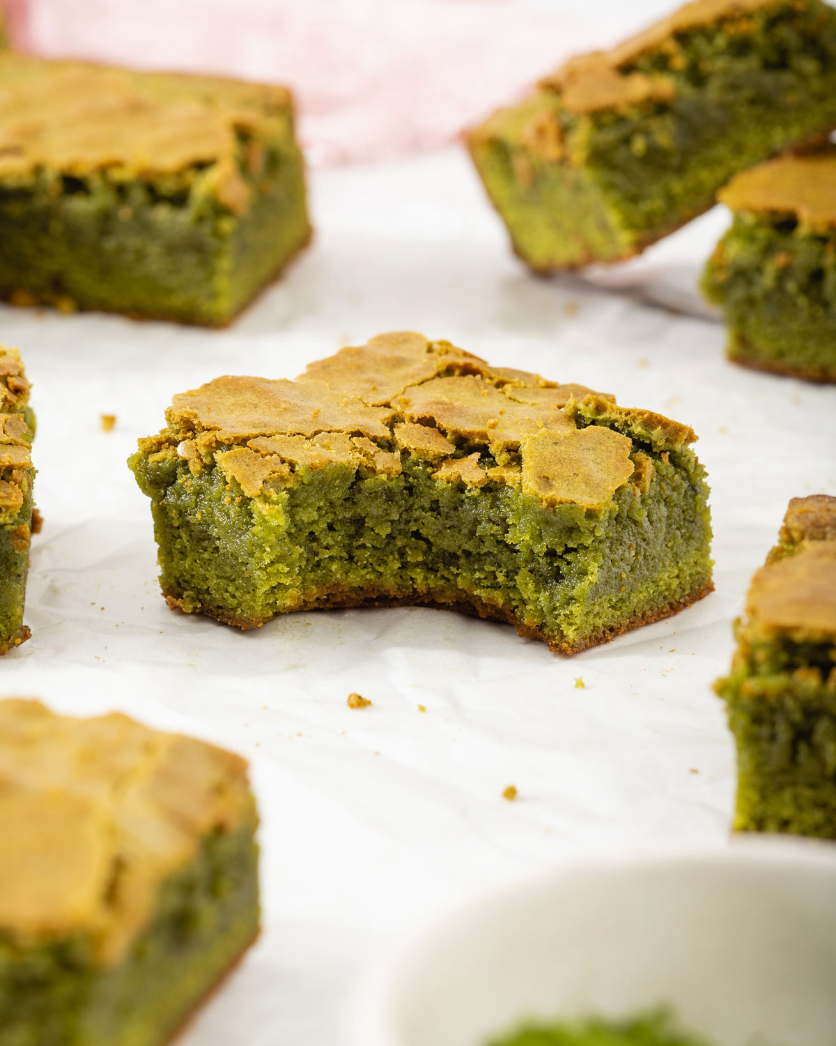A matcha brownie with a bite out of it.