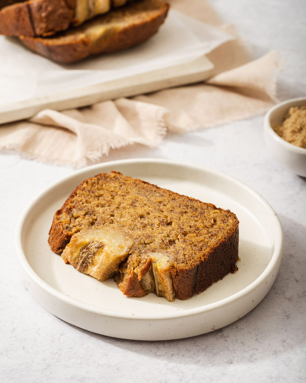 A slice of miso banana bread on a small plate.